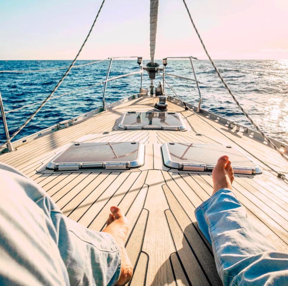 Feet on yacht deck looking at the sea