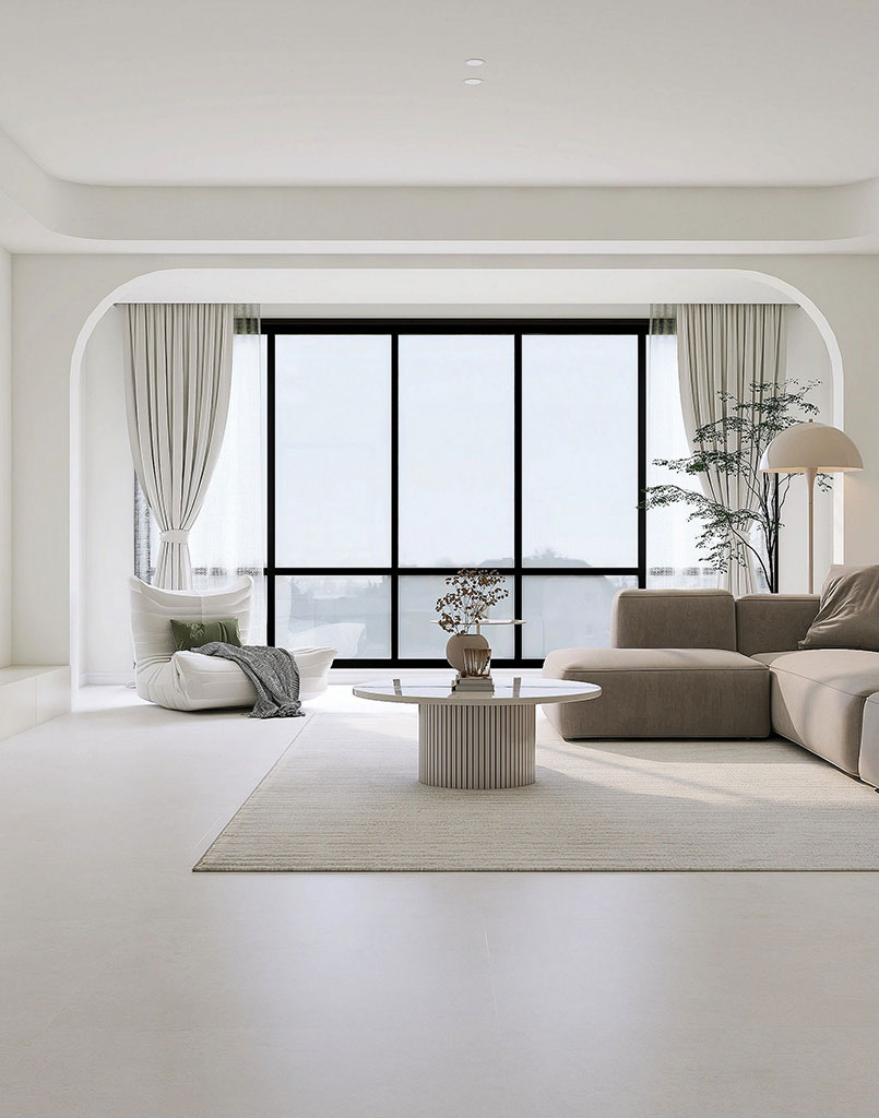 A modern living room with a minimalist design, featuring a comfortable sofa, a coffee table, and large windows that allow natural light to fill the space.