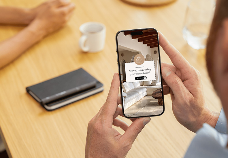 Real estate presenting a property on a smartphone to a client