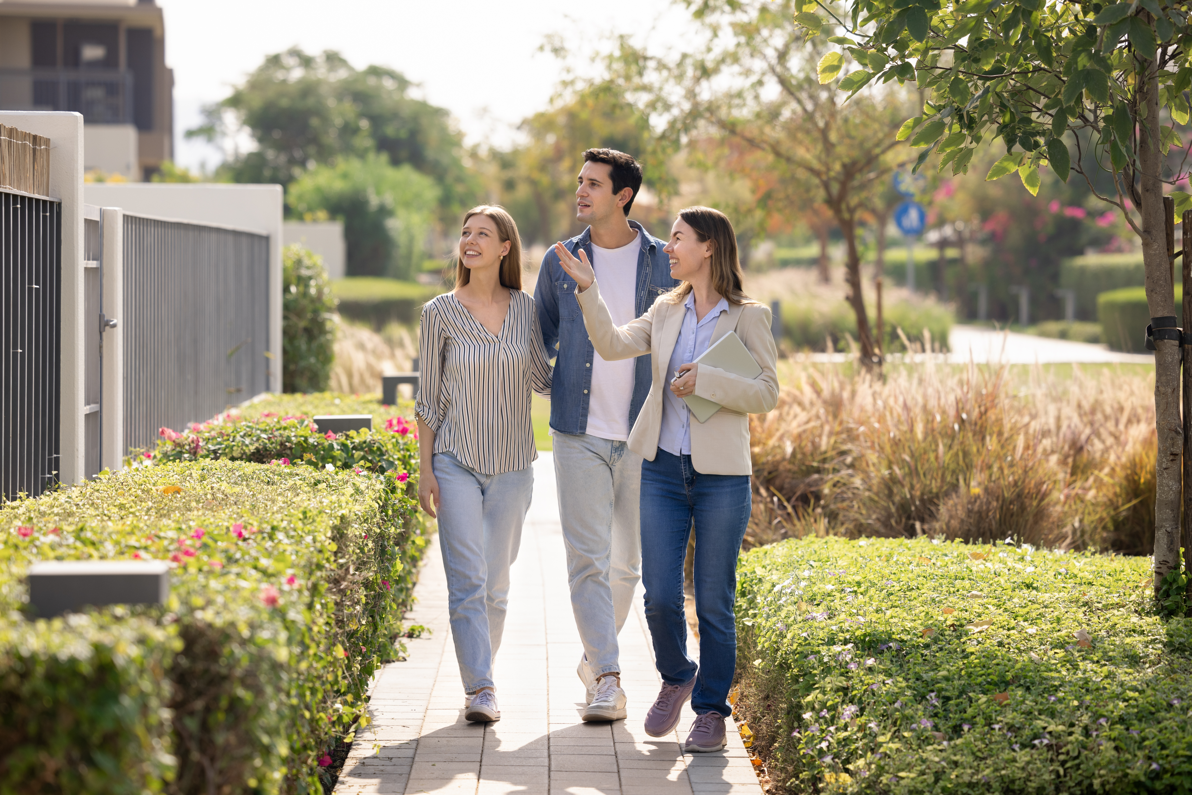 A real estate agent is showing a property to a married couple.