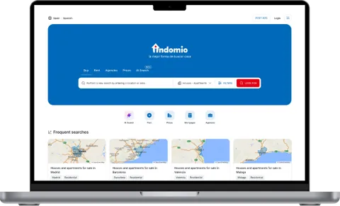 Indomio.com property portal shown on a laptop
