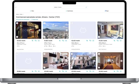 Spitogatos.gr property portal shown on a laptop